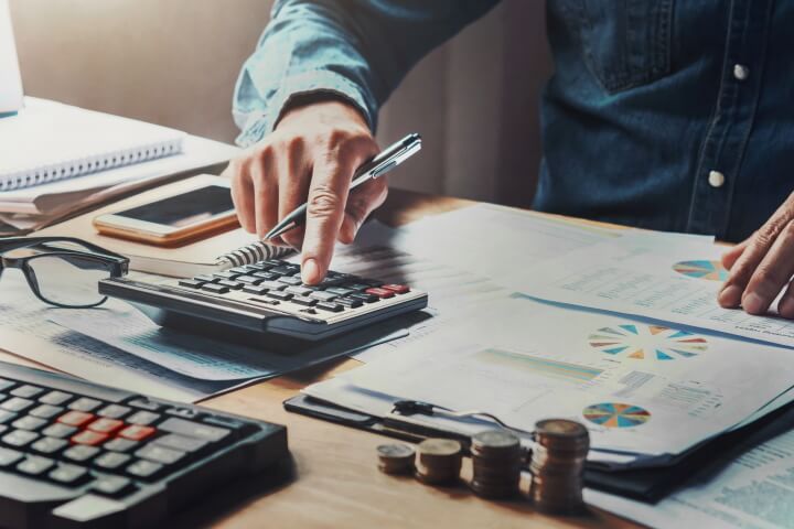 A man using a calculator and money.