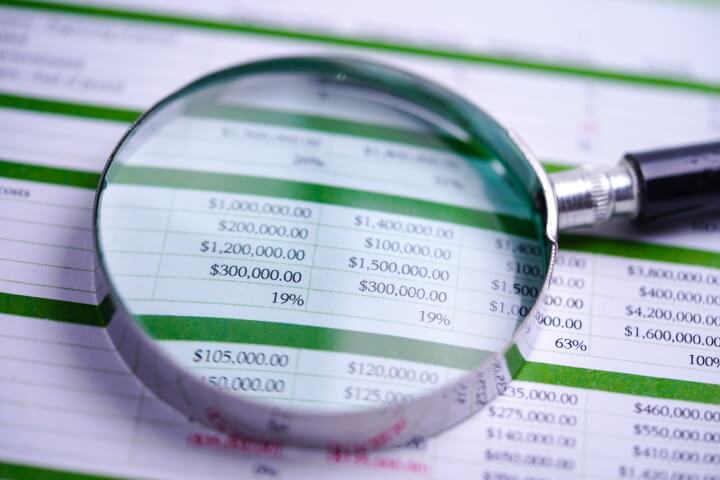 A magnifying glass on a spreadsheet